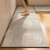 A long, rectangular kitchen floor mat with a geometric line pattern is placed on a light wood floor.