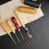 A professional leather crafting tool kit showing waxed thread, a spool, and various needles and awls on a beige cloth.