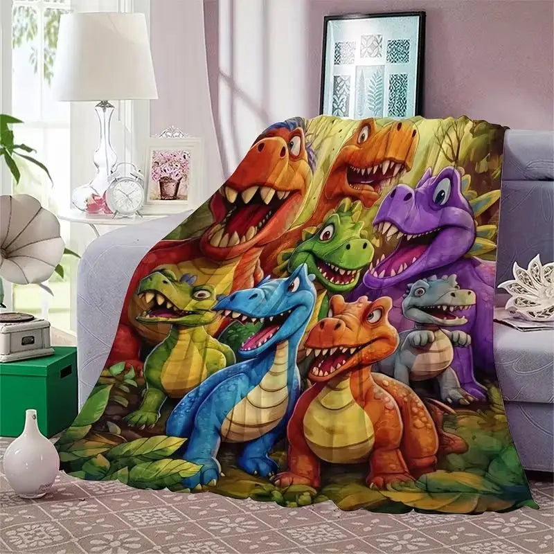 A colorful print of various dinosaurs in shades of green, orange, and purple on a flannel throw blanket.