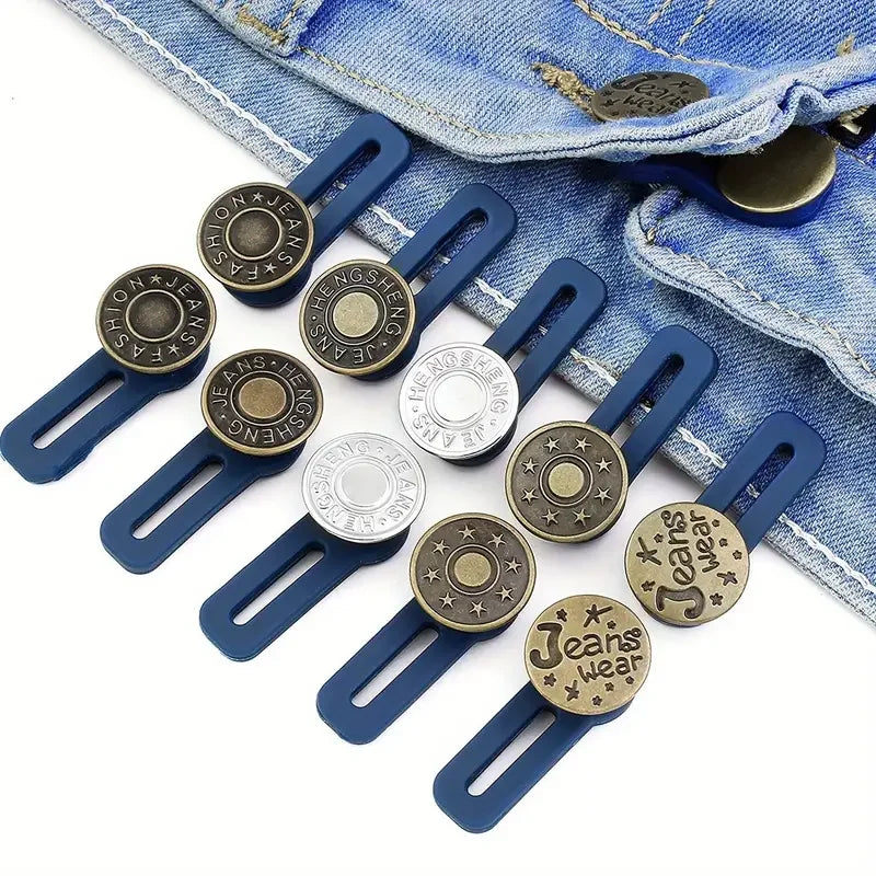 A set of adjustable button extenders for pants in various sizes and finishes, displayed on a denim jean fabric.