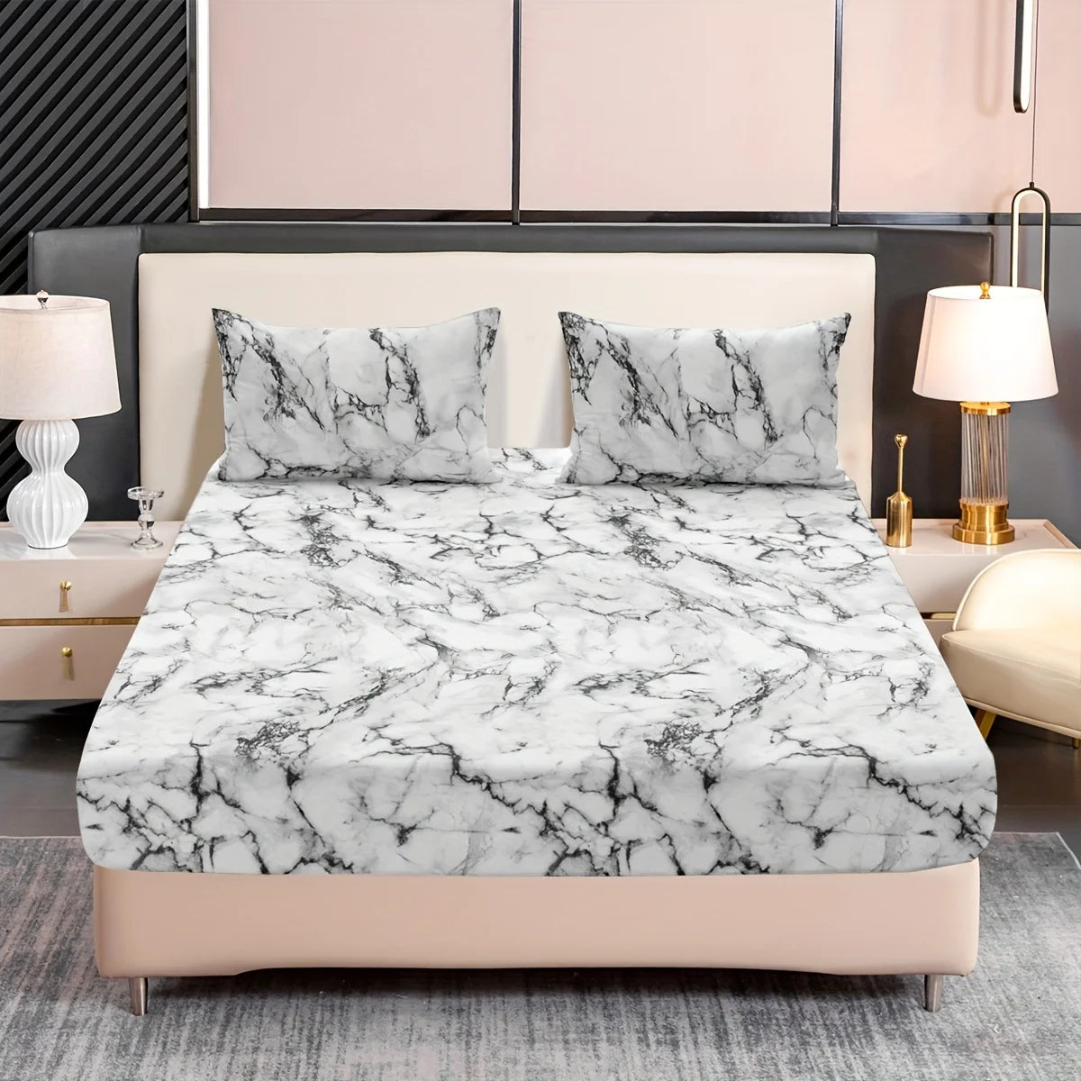 A fitted sheet set featuring a white and gray marble print on a bed with matching pillows.