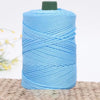 A spool of light blue 3mm ice rope crochet yarn for crafting placed on a woven mat.