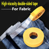 Yellow high viscosity double-sided fabric tape rolled on a denim shirt.