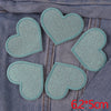 A pack of five glitter iron-on embroidered love heart star patches on a denim fabric background.