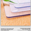 A clear plastic mat with rounded corners protects a table surface, demonstrating the smooth edge design.