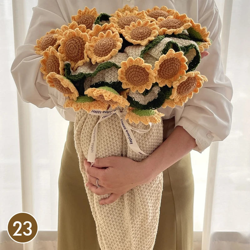 A hand knitted floral rose bouquet arrangement wrapped in a beige throw blanket.