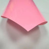 A sheet of pink 3D puff heat transfer vinyl, folded into a triangular shape.