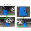 Demonstration of a thick blue protective kneeling mat being rolled on a car's tire.