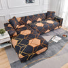 A dark blue sofa protector cover featuring an abstract geometric pattern in orange and gold tones.