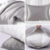 Close-up shots of a smooth gray satin pillowcase and pillow, showing the fabric texture and folds.