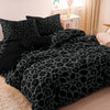 A black and gray leopard print duvet cover set displayed on a bed.