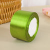 A roll of bright lime green satin ribbon used for crafts and gift wrapping.