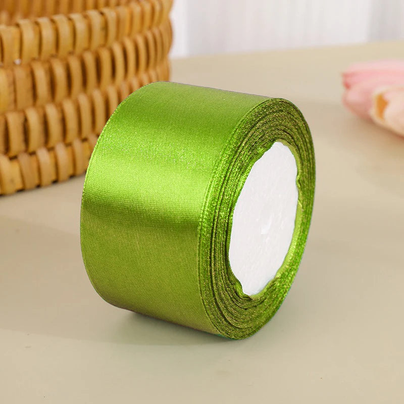 A roll of bright lime green satin ribbon used for crafts and gift wrapping.