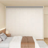 A heavy duty foldable room divider curtain in white with vertical pleats is shown in a bedroom setting.