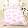 Pink bedding set featuring a butterfly pattern on a duvet cover and pillows.