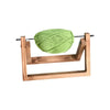 A handmade rotating yarn storage rack holding a ball of light green yarn.
