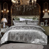 A luxurious silver damask duvet cover set displayed on a bed with ornate gold framing and dark wood paneling.