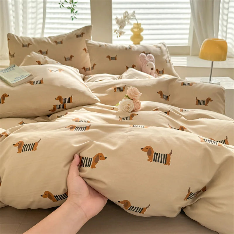 A beige duvet cover featuring a pattern of small brown and black dog silhouettes.