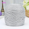 A ball of silver metallic silk yarn used for crocheting and knitting.