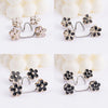 Silver and gold floral button clips used for adjusting jeans waist tightness