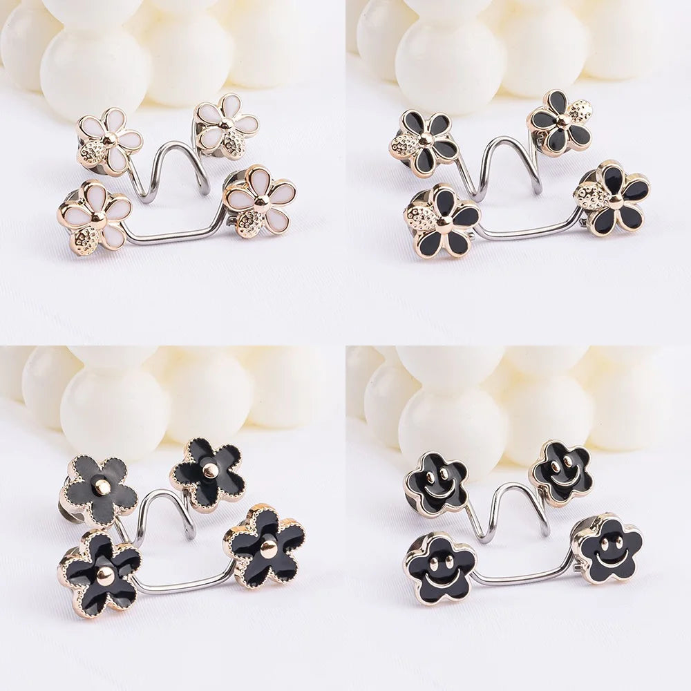 Silver and gold floral button clips used for adjusting jeans waist tightness