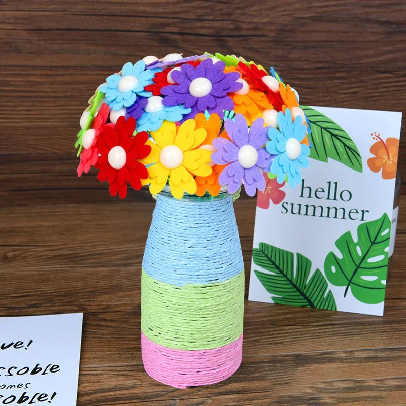 A bouquet of colorful felt flowers in a glass vase with a greeting card for summer