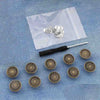 Silver metal button pins are displayed on a translucent bag with a blue denim background.