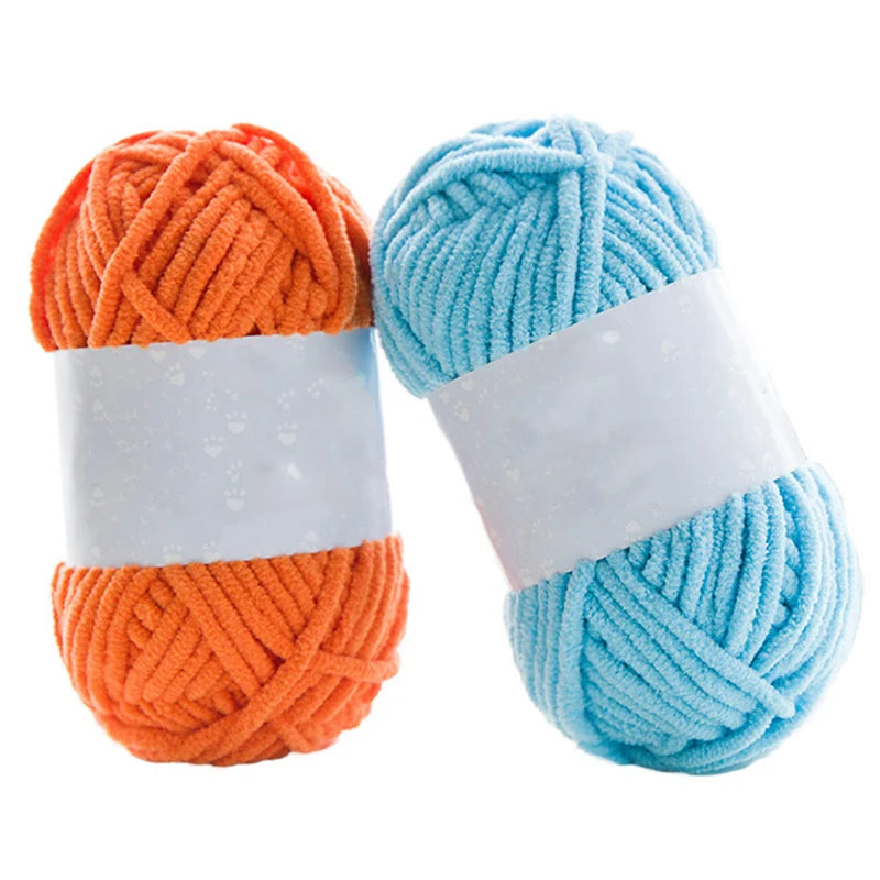 Two skeins of thick velvet yarn, one orange and one light blue, for knitting and crochet projects.