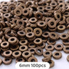 A pile of small, round, bronze-colored geometric acrylic beads for jewelry making