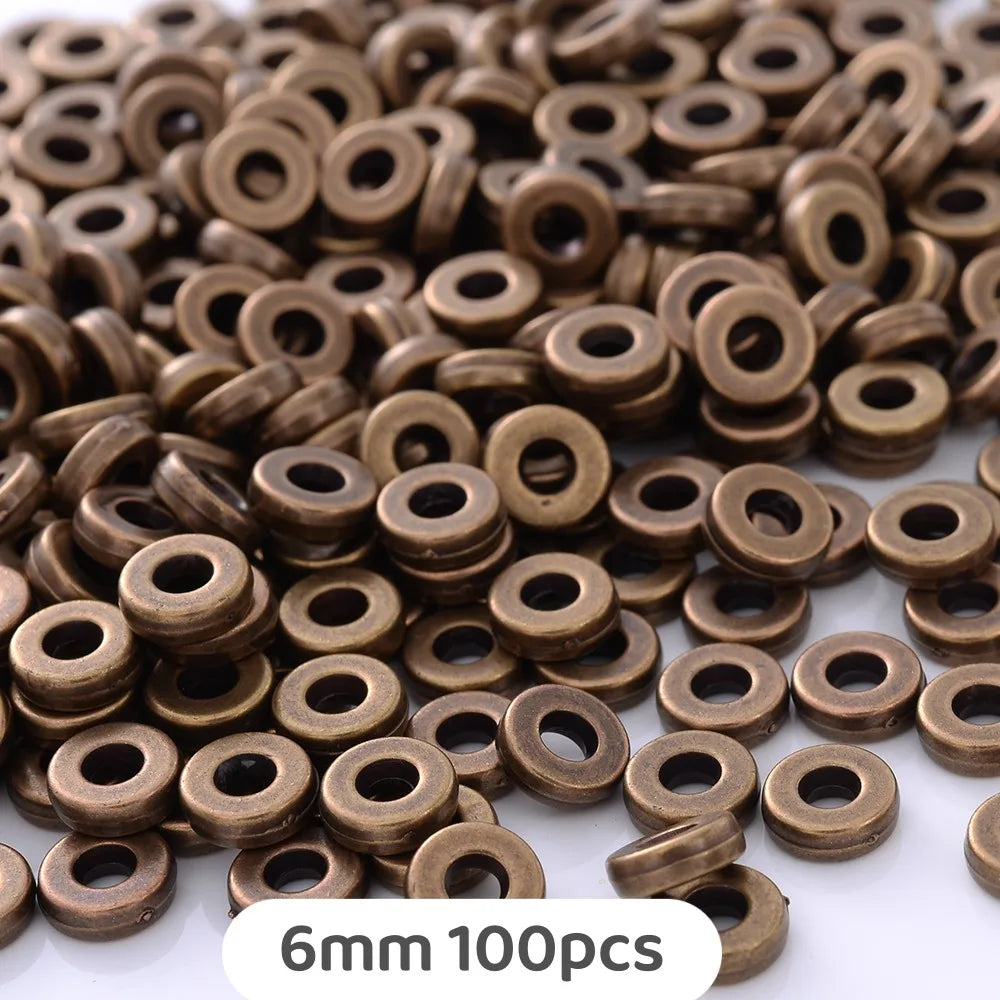 A pile of small, round, bronze-colored geometric acrylic beads for jewelry making