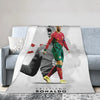 A football player wearing a red jersey and green shorts is featured on a throw blanket.