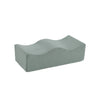 A light gray ergonomic memory foam leg support pillow.
