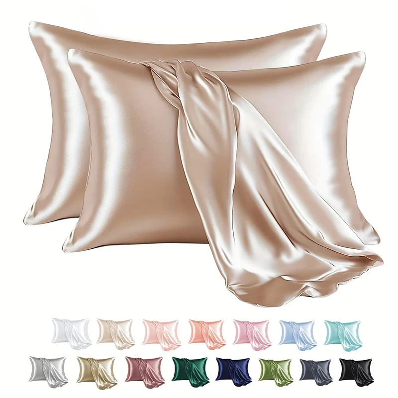 A collection of satin pillowcases in various shades of pink, beige, and green are displayed.