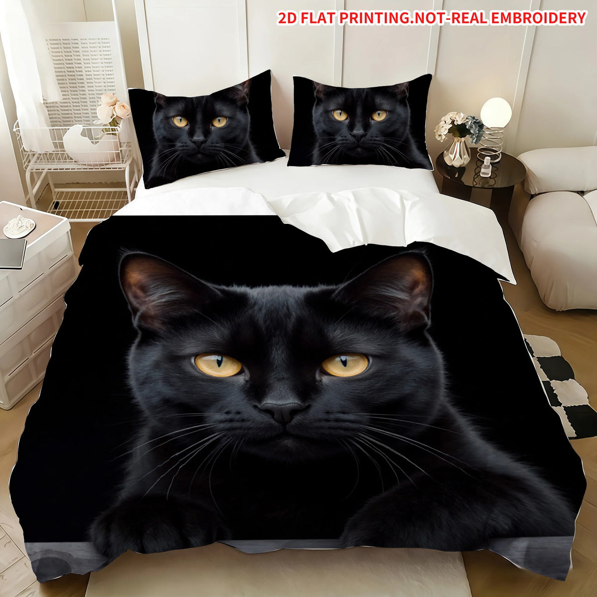 A black cat face print on a blanket displayed on a bed with white bedding.