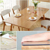 A wooden table with a clear heat-resistant PVC tablecloth protector and a tablet showing smooth edges.