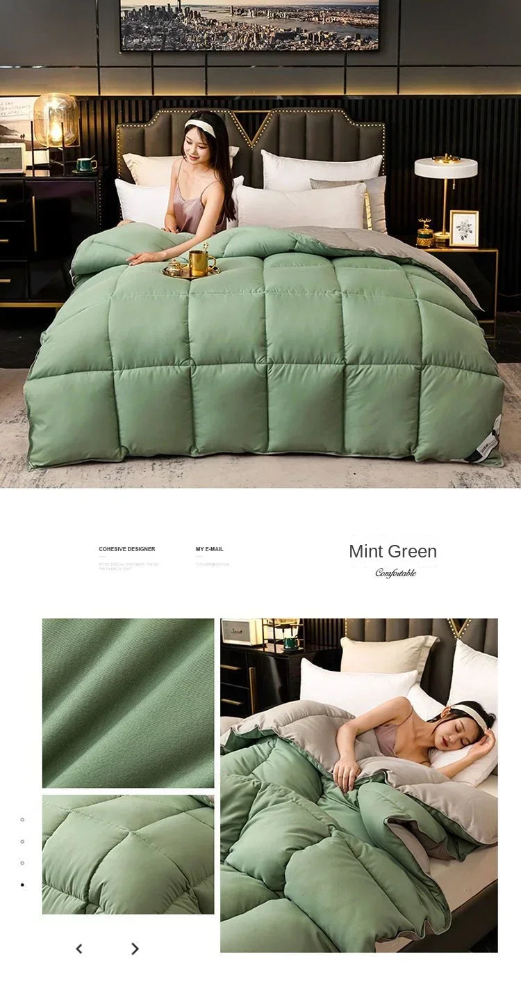A mint green quilted comforter duvet displayed on a bed with dark wood accents and pillows.