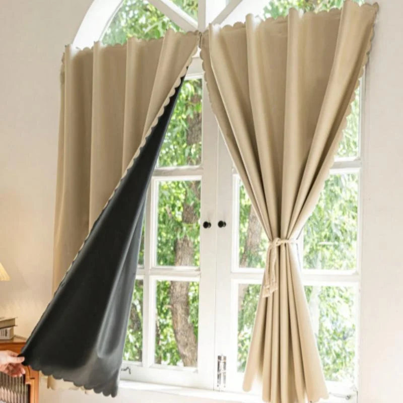 Self-adhesive black blackout curtains in beige fabric hanging on a white window frame.