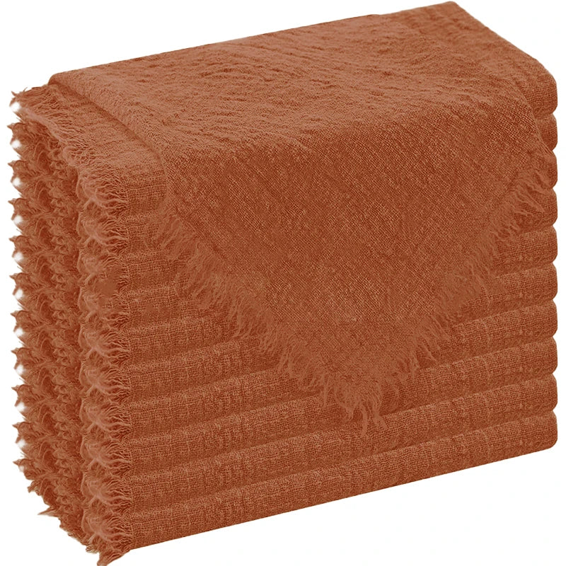 A stack of rust-colored, textured cloth napkins.