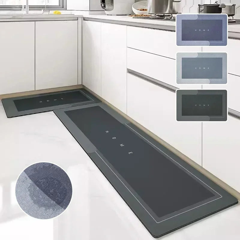 A dark gray diatom mud floor mat is shown placed on a kitchen countertop next to several small square mats.
