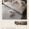 A luxury chenille sofa cover in beige and gray tones with decorative pillows on a modern sofa.