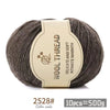 A ball of gray wool thread with a label indicating the product is a Medium Coarse Alpaca Wool Yarn Kit for Knitting.