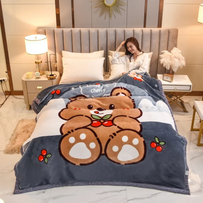 A plush mink fleece king size blanket featuring a brown bear design with red accents, displayed on a bed.