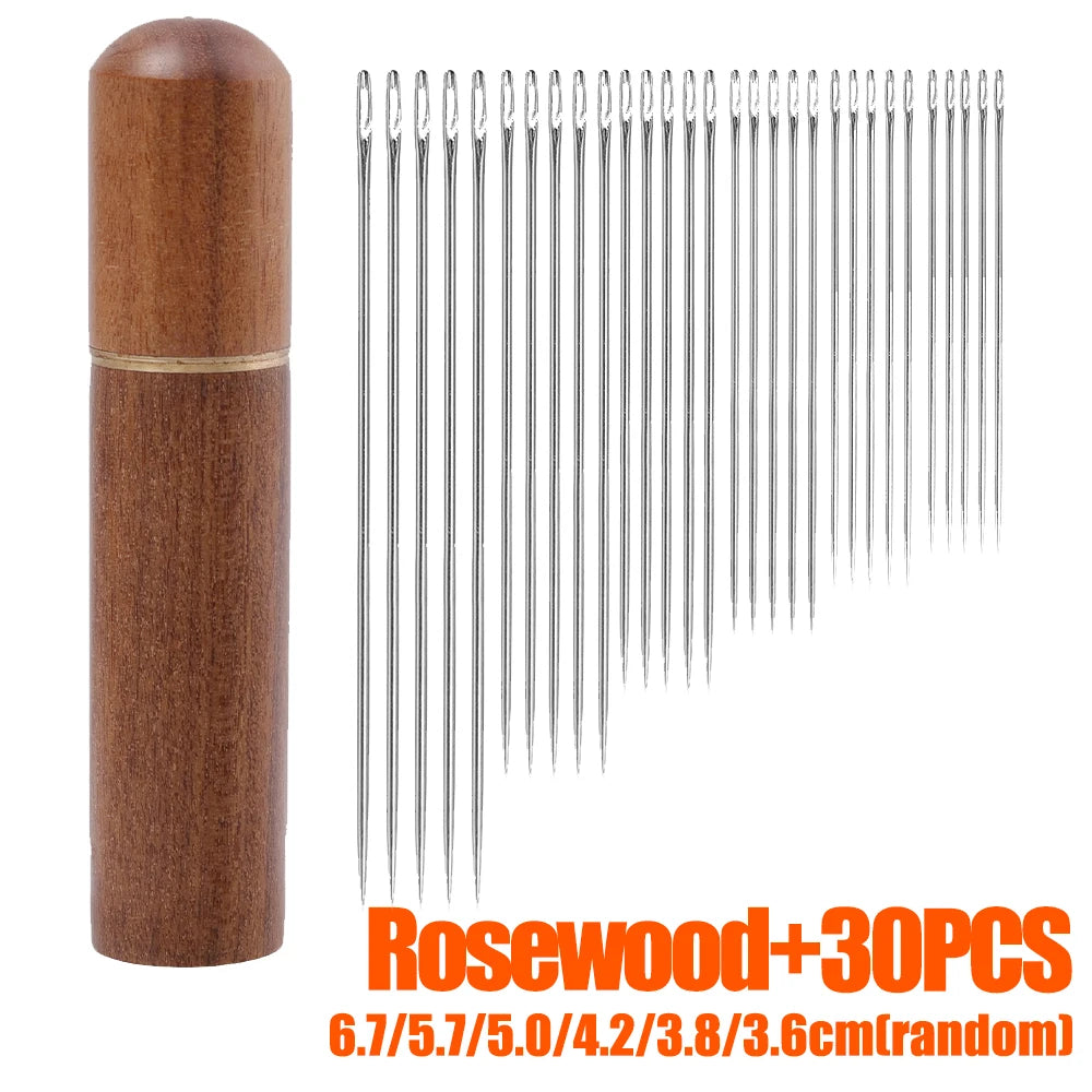 A set of 30 multi-size hand sewing needles with a wooden storage tube.