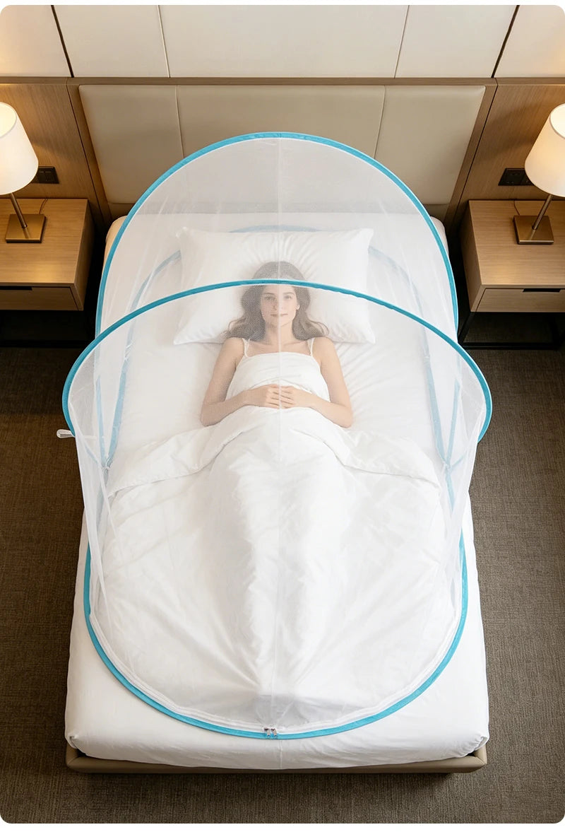 A white bed with a mosquito net draped over it, featuring a woman lying in the center.