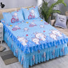 A set of three blue and white patterned fitted bed sheets with elastic lace trim displayed on a bed.