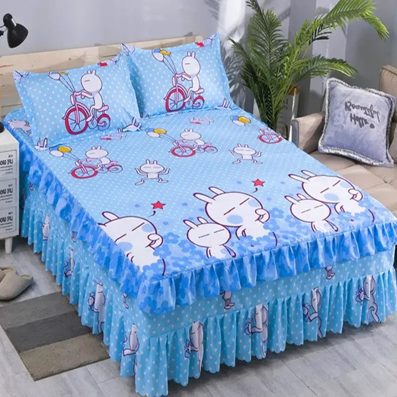 A set of three blue and white patterned fitted bed sheets with elastic lace trim displayed on a bed.
