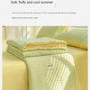 A light green Korean style seersucker summer quilt set displayed on a bed with natural light.