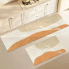A rectangular kitchen floor mat with beige and terracotta stripes is displayed on a white cabinet surface.