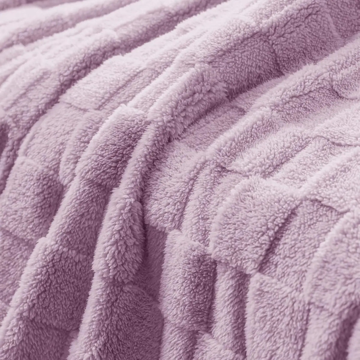 A close-up of a soft, lavender checkered fleece throw blanket with a textured surface.