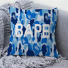 A decorative pillow cover featuring a blue and white camouflage pattern with the word BAPE.